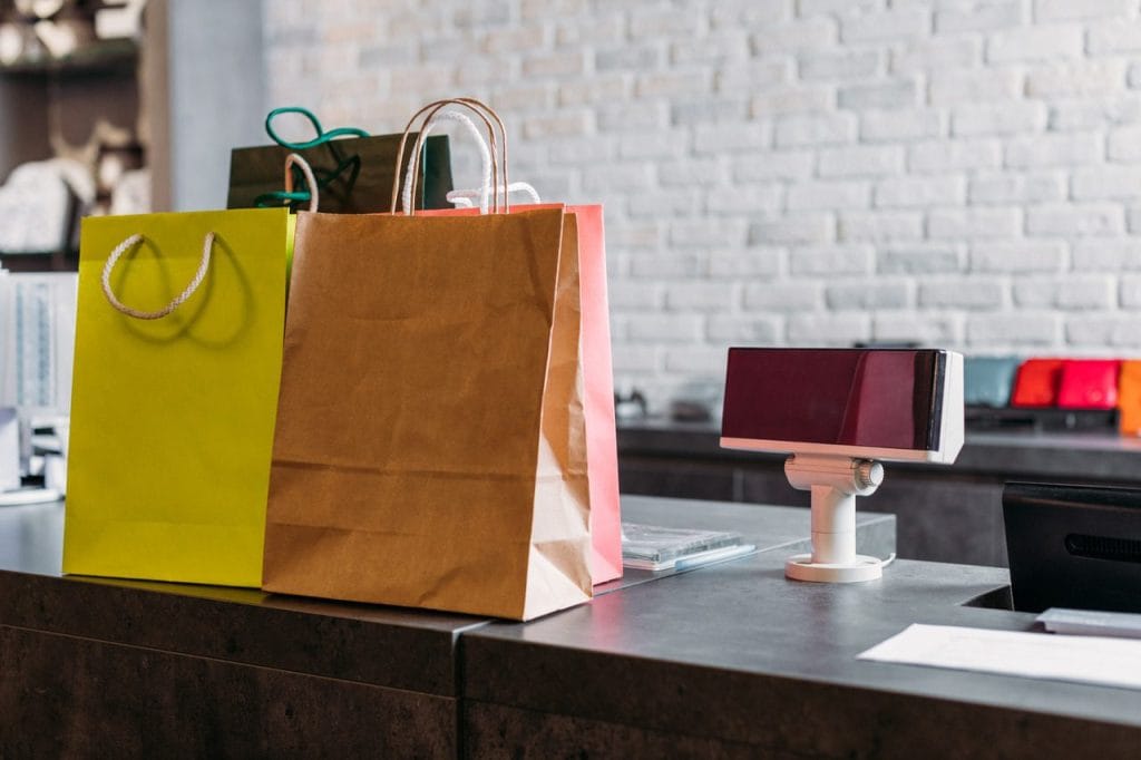 shopping bags standing on cash register in shoppin 2024 11 19 00 18 13 utc Easy Resize.com